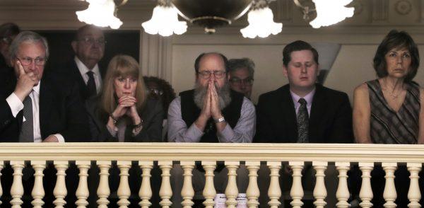 Rob Spencer, center, of Concord, N.H. pauses in prayer as legislators debate prior to a death penalty vote at the State House in Concord, N.H., on May 30, 2019. (Charles Krupa/AP Photo)