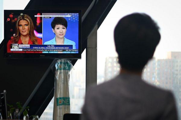 China's state broadcaster CGTN anchor Liu Xin looks at a screen showing her debate with Fox Business Network anchor Trish Regan, at the CCTV headquarters in Beijing on May 30, 2019. (Wang Zhao/AFP/Getty Images)