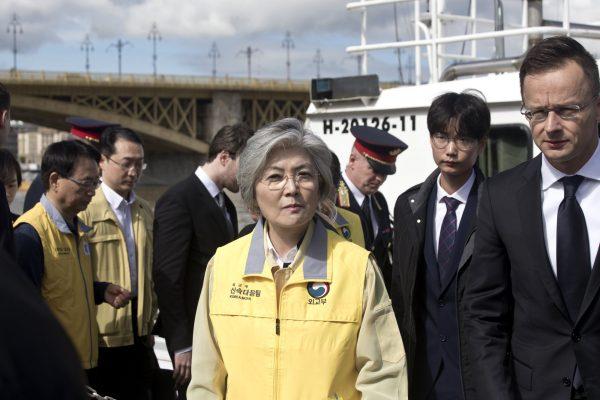 Kang Kyung-wha, center, foreign minister of South Korea, together with her Hungarian counterpart, Peter Szijjarto, right, visits the bank of the Danube River close to Margit Bridge where a sightseeing boat capsized in Budapest, Hungary, on May 31, 2019. (Marko Drobnjakovic/P Photo)