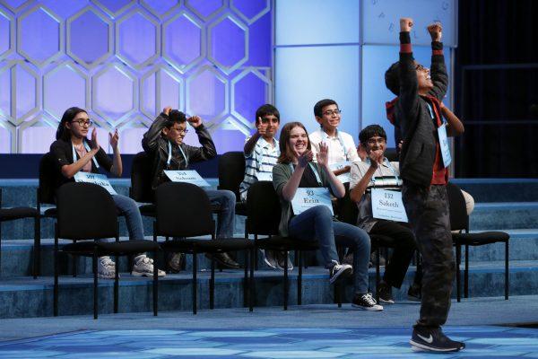 Rishik Gandhasri, right, 13, of San Jose, Calif., celebrates after becoming one of eight co-champions in the finals of the Scripps National Spelling Bee, on May 31, 2019. (Patrick Semansky/AP photo)