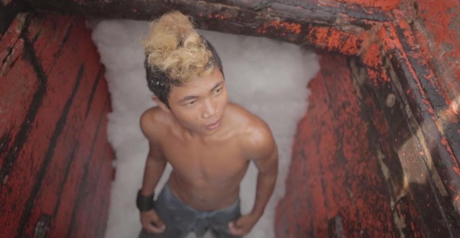 A teenage Thai slave in a fishing boat's hold filled with ice, in "Ghost Fleet." (Vulcan Productions)