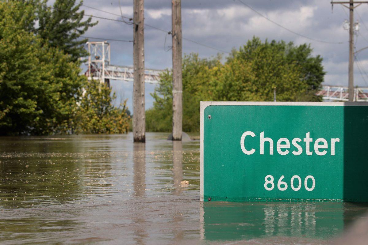 A street sign, marking the edge of town along Kaskaskia Street pokes out of floodwater from the Mississippi River in Chester, Ill., on May 30, 2019. (Scott Olson/Getty Images)