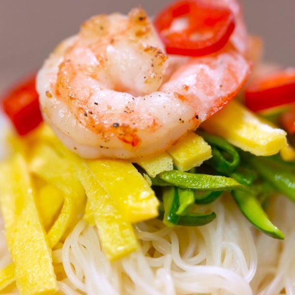 Rice noodle soup with shrimp, zucchini, and egg.