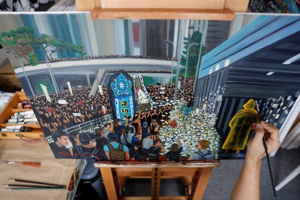 Artist Perry Dino paints "No Extradition to China Road Worship to Hero in Pacific Place" at his studio, in Hong Kong, on June 20, 2019. (REUTERS/Tyrone Siu)