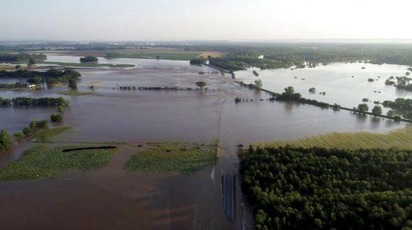 In this aerial image provided by Yell County Sheriff's Department water rushes through the levee along the Arkansas River, Dardanelle, Ark., on May 31, 2019. (Yell County Sheriff's Department via AP)