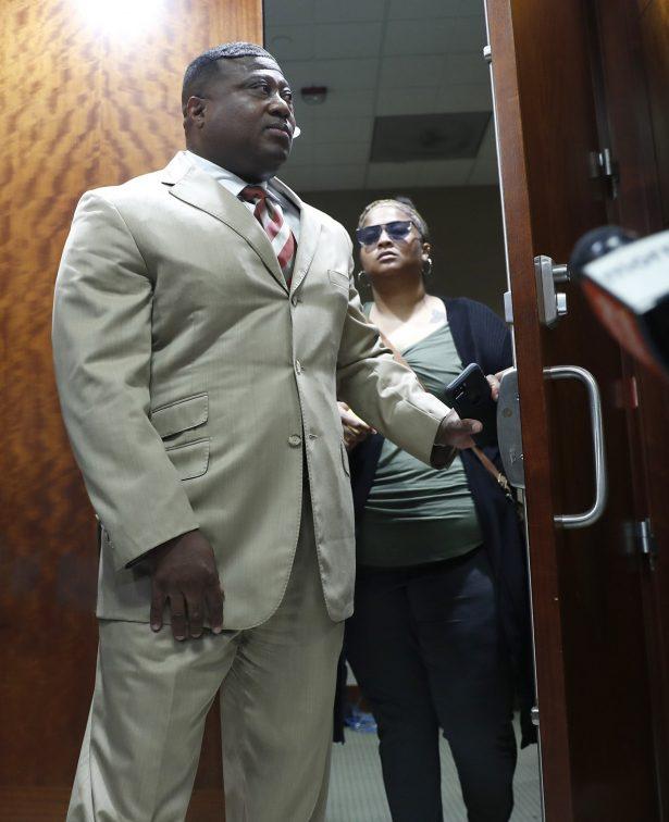Quanell X walks out of the courtroom with Brittany Bowens, the mother of the missing 4-year-old, Meleah Davis, in Houston on May 13, 2019. (Karen Warren/Houston Chronicle via AP)