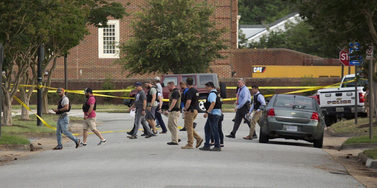 Police work the scene where 12 people were killed during a mass shooting at the Virginia Beach city public works building, in Virginia Beach, Va. on May 31, 2019. (L. Todd Spencer/The Virginian-Pilot via AP)