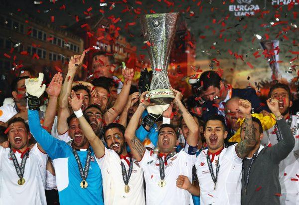 Captain Jose Antonio Reyes (C) of Sevilla lifts the Europa League trophy as players celebrate at the award ceremony after the UEFA Europa League Final match between Liverpool and Sevilla at St. Jakob-Park in Basel, Switzerland on May 18, 2016. (Michael Steele/Getty Images)