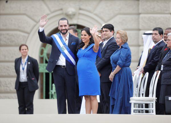 El Salvador President Nayib Bukele waves to the audience beside his pregnant wife, Gabriela de Bukele, after receiving the presidential sash during his swearing-in ceremony in San Salvador, on June 1, 2019. (Reuters/Jose Cabezas)