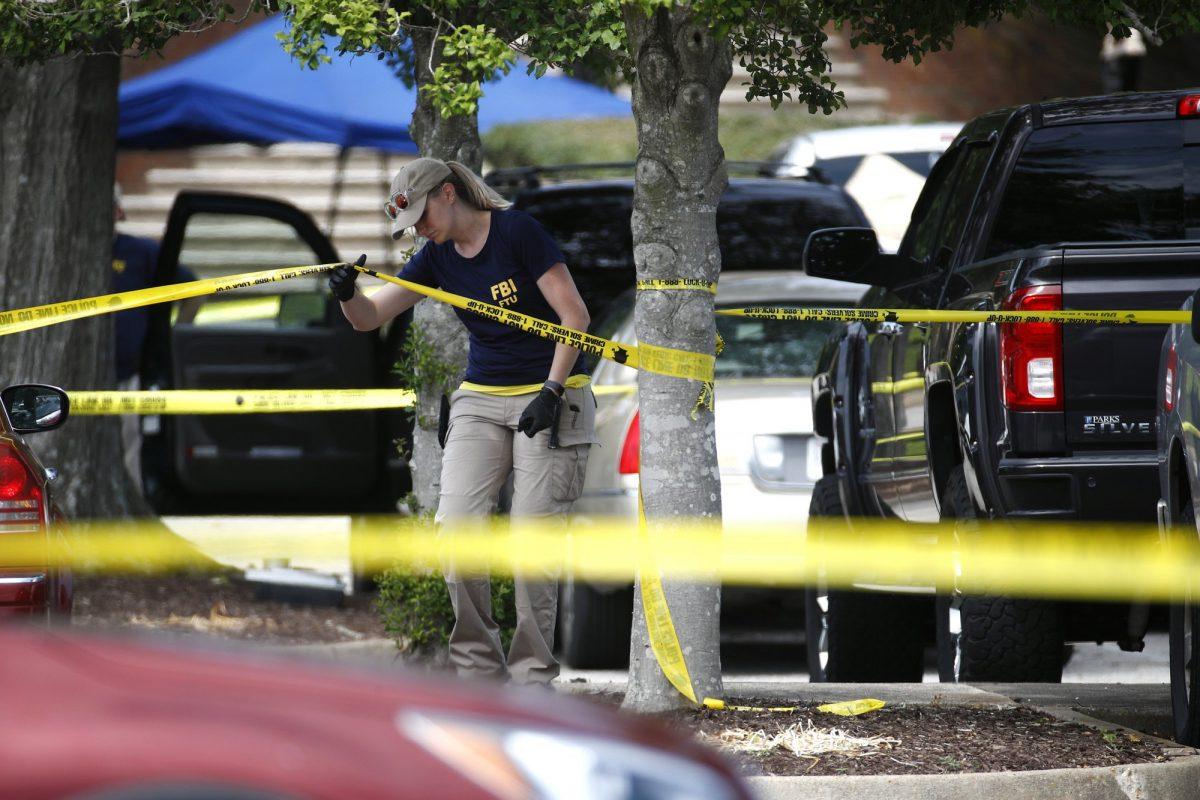 A member of an FBI works in a parking lot outside a municipal building that was the scene of a shooting in Virginia Beach, Va., on June 1, 2019. (Patrick Semansky/AP Photo)