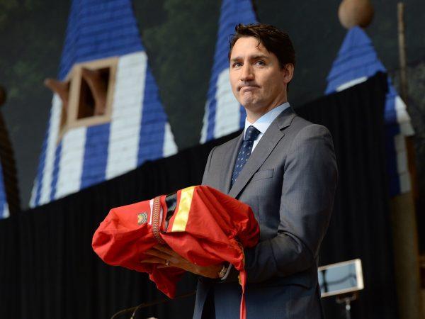 Prime Minister Justin Trudeau stands after being presented with the final report at the closing ceremony for the National Inquiry into Missing and Murdered Indigenous Women and Girls in Gatineau, Que., on June 3, 2019. (Adrian Wyld/The Canadian Press)