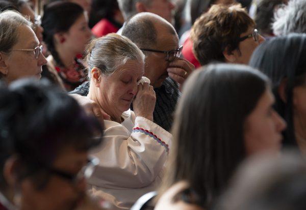 A man and woman show their emotions during ceremonies marking the release of the Missing and Murdered Indigenous Women report in Gatineau, on June 3, 2019. (Adrian Wyld/The Canadian Press)