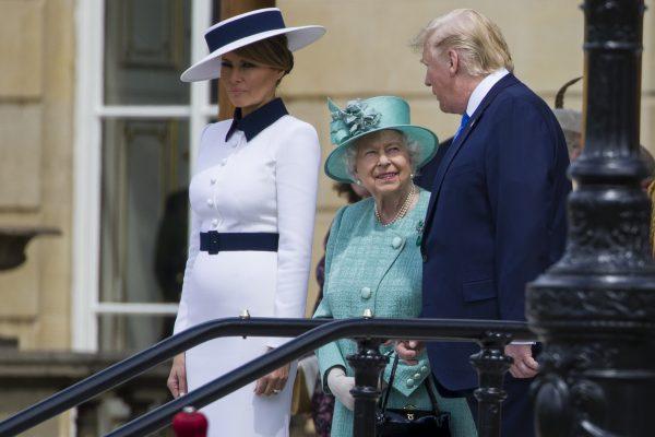 First lady Melania Trump, left, stands as Queen Elizabeth II smiles while talking with President Donald Trump at Buckingham Palace, Monday, June 3, 2019, in London. (AP Photo/Alex Brandon)