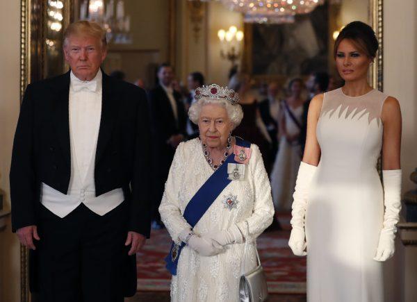 Britain's Queen Elizabeth II (center) poses for a photo with US President Donald Trump, and first lady Melania Trump ahead of the State Banquet at Buckingham Palace in London on Monday, June 3, 2019. Trump is on a three-day state visit to Britain. (Alastair Grant/AP Photo)