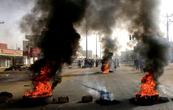 Sudanese protesters use burning tires to erect a barricade on a street, demanding that the country's Transitional Military Council hand over power to civilians, in Khartoum, Sudan on June 3, 2019. (Stringer/Reuters)