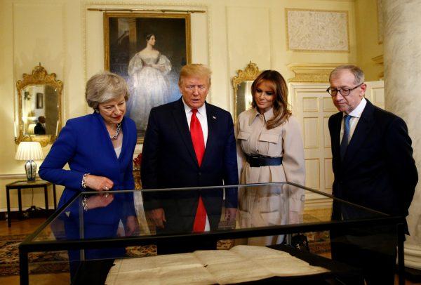 President Donald Trump and First Lady Melania Trump review items with Britain's Prime Minister Theresa May and her husband Philip in Downing Street, as part of Trump's state visit in London on June 4, 2019. (Henry Nicholls/Pool/Reuters)