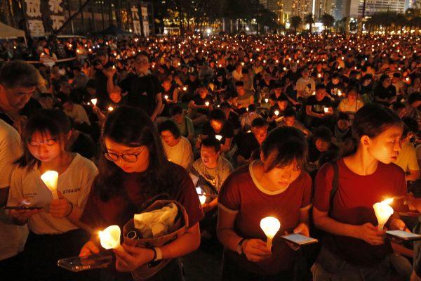 Thousands of people attend a candlelight vigil for victims of the Chinese government's brutal military crackdown three decades ago on protesters in Beijing's Tiananmen Square at Victoria Park in Hong Kong, June 4, 2019. (AP Photo/Kin Cheung)