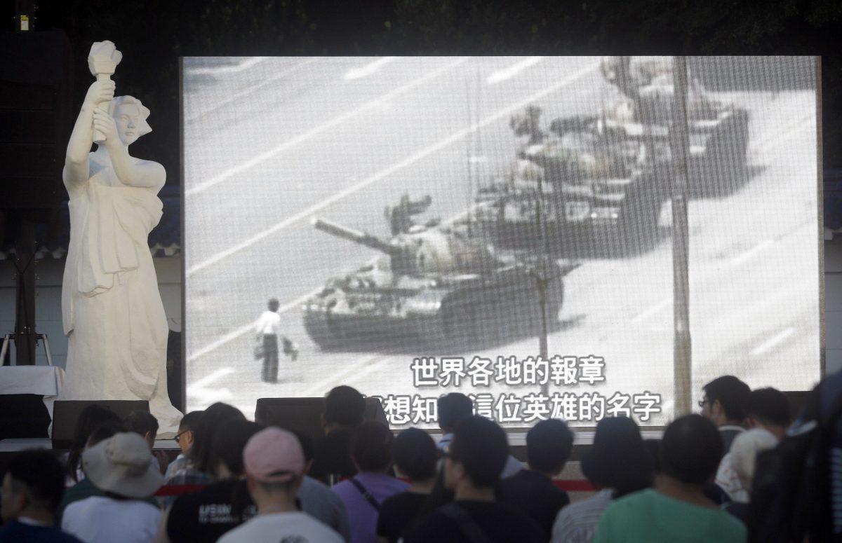 People watch a giant screen as they attend the Tiananmen Anniversary at Democracy Square in Taipei, Taiwan, on June 4, 2019, to mark the 30th anniversary of the Chinese military crackdown on the pro-democracy movement in Beijing's Tiananmen Square. (Chiang Ying-ying/AP)