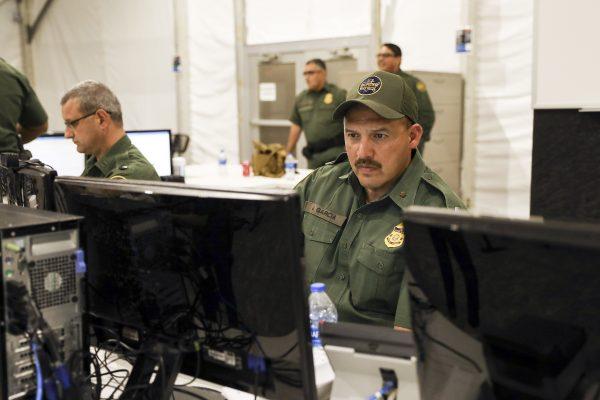 A Border Patrol agent works at a terminal for intake and processing at the new Border Patrol tent facility for holding illegal immigrants in Donna, Texas, on May 2, 2019. Similar facilities are currently being constructed for ICE. (Charlotte Cuthbertson/The Epoch Times)