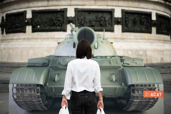 An activist stands in front of an image of a tank in Paris, France, replicating the scene where an unknown Chinese man, known as the “Tank Man,” stood in front of a column of tanks during the 1989 Tiananmen Square protests in Beijing, to mark the 30th anniversary of the Tiananmen Square massacre on June 4, 2019. (Stringer/AFP/Getty Images)