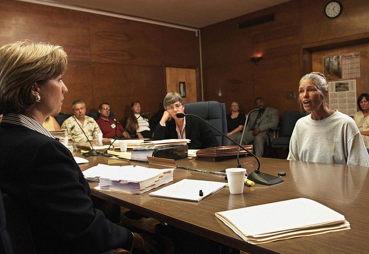 Sheron Lawin (L), a member of the Board of Prison Terms commissioners, listens to Leslie Van Houten (R), after her parole was denied at the California Institution for Women in Corona, Calif., on June 28, 2002. (Damian Dovarganes/AFP/Getty Images)