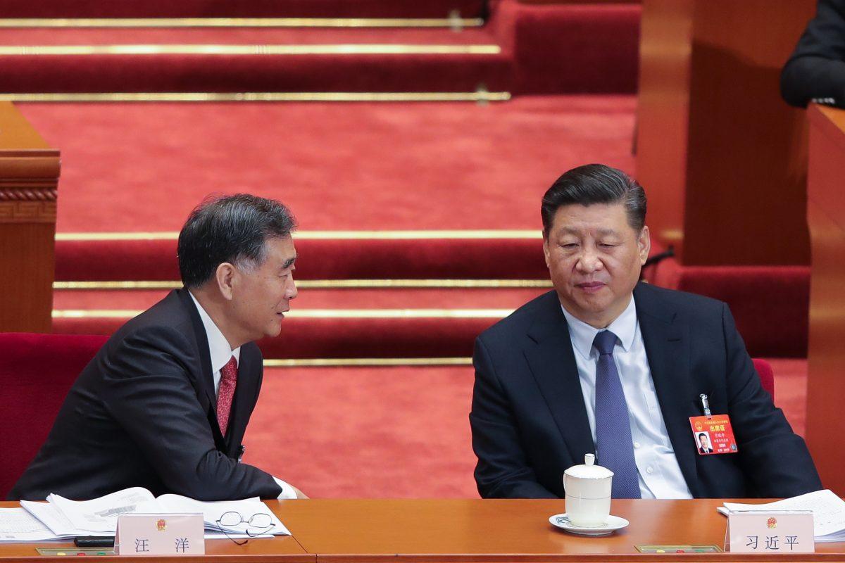 Chinese leader Xi Jinping (R) speaks with the Chairman of the Chinese People's Political Consultative Conference Wang Yang (L) during the opening of the second session of the 13th National People's Congress at the Great Hall of the People in Beijing, on March 5, 2019. (Lintao Zhang/Getty Images)