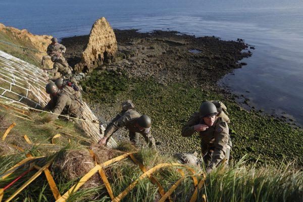 Soldiers from the U.S. 75th Ranger Regiment, in period dress, climb the cliff of Pointe-du-Hoc in Cricqueville-en-Bessin, Normandy, France, Wednesday, June 5, 2019. During the American assault of Omaha and Utah beaches on June 6, 1944, U.S. Army Rangers scaled the 100-foot cliffs to seize German artillery pieces that could have fired on the American landing troops. (AP Photo/Thibault Camus)