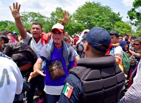 Migrants gesture while arguing with a federal police officer during a joint operation by the Mexican government to stop a caravan of Central American migrants on their way to the U.S., at Metapa de Dominguez, in Chiapas state, Mexico, on June 5, 2019. (Jose Torres/Reuters)