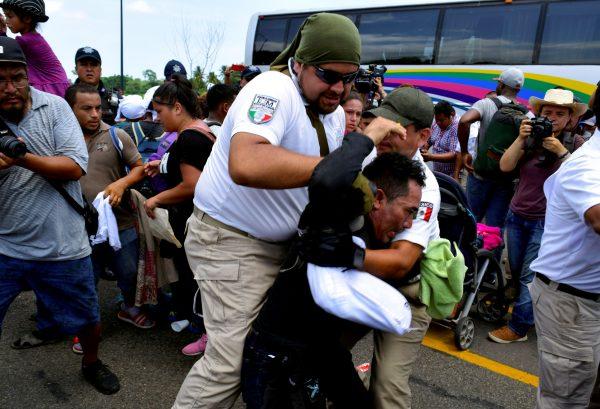 Personnel of the National Immigration Institute (INM) detain a migrant during a joint operation by the Mexican government to stop a caravan of Central American migrants on their way to the U.S., at Metapa de Dominguez, in Chiapas state, Mexico, on June 5, 2019. (Jose Torres/Reuters)