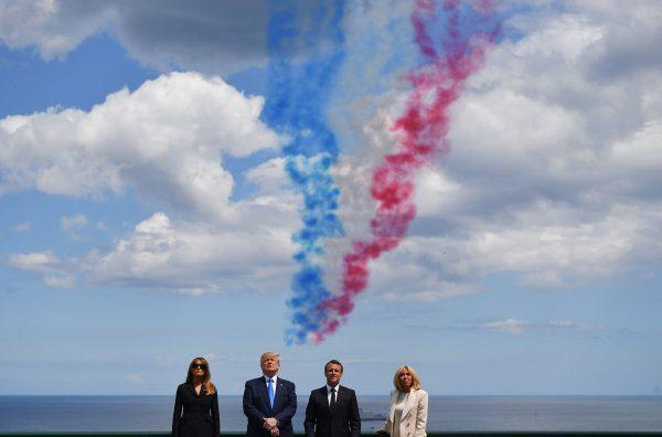 (From L) US First Lady Melania Trump, US President Donald Trump, French President Emmanuel Macron and French President's wife Brigitte Macron watch as French elite acrobatic flying team "Patrouille de France" (PAF) fly over after a French-US ceremony at the Normandy American Cemetery and Memorial in Colleville-sur-Mer, Normandy, northwestern France, on June 6, 2019, as part of D-Day commemorations marking the 75th anniversary of the World War II Allied landings in Normandy. (Mandel Ngan/AFP/Getty Images)