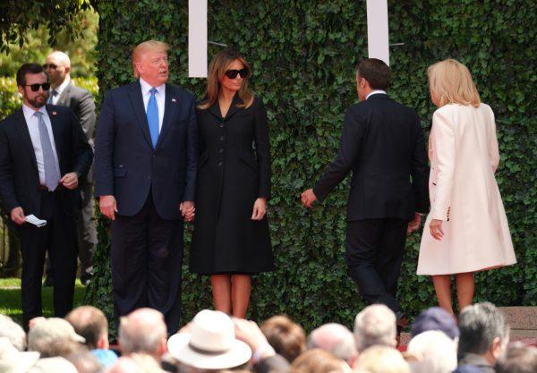 (L-R) U.S. President Donald Trump, American First Lady Melania Trump, French President Emmanuel Macron and French First Lady Brigitte Macron leave the stage during the main ceremony to mark the 75th anniversary of the World War II Allied D-Day invasion of Normandy at Normandy American Cemetery on June 06, 2019 near Colleville-Sur-Mer, France. Veterans, families, visitors, political leaders and military personnel are gathering in Normandy to commemorate D-Day, which heralded the Allied advance towards Germany and victory about 11 months later. (Sean Gallup/Getty Images)