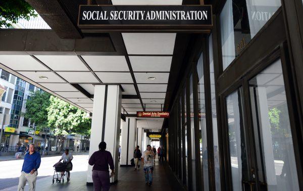 Pedestrians walk past the Social Security Administration office in downtown Los Angeles, on October 1, 2013 in California. (FREDERIC J. BROWN/AFP/Getty Images)