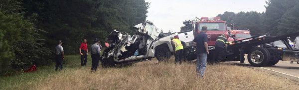 In this photo provided by The Macon Beacon, authorities remove one of several vehicles involved in a fatal crash near Scooba, Miss., on June 5, 2019. (Jeanette Unruh/The Macon Beacon via AP)