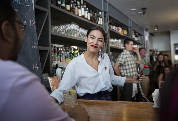 Rep. Alexandria Ocasio-Cortez works behind the bar at the Queensboro Restaurant in the Queens borough of New York City on May 31, 2019. (Drew Angerer/Getty Images)