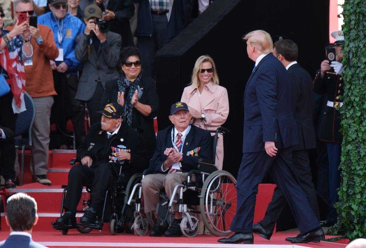 President Donald Trump and French President Emmanuel Macron greet U.S. Battle of Normandy veterans and family members as the two men arrive at the main ceremony to mark the 75th anniversary of the World War II Allied D-Day invasion of Normandy, at Normandy American Cemetery near Colleville-Sur-Mer, France on June 6, 2019. (Sean Gallup/Getty Images)