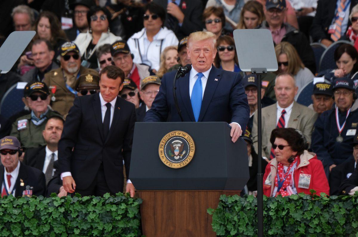 President Donald Trump speaks as French President Emmanuel Macron (C-L) and American Battle of Normandy veterans and family members look on at the main ceremony to mark the 75th anniversary of the World War II Allied D-Day invasion of Normandy at Normandy American Cemetery near Colleville-Sur-Mer, France, on June 6, 2019. (Sean Gallup/Getty Images)
