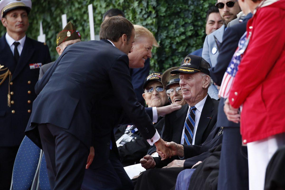 President Donald Trump and French President Emmanuel Macron greet veterans as they arrive to a ceremony to commemorate the 75th anniversary of D-Day at The Normandy American Cemetery in Colleville-sur-Mer, Normandy, France on June 6, 2019. (Alex Brandon/AP Photo)