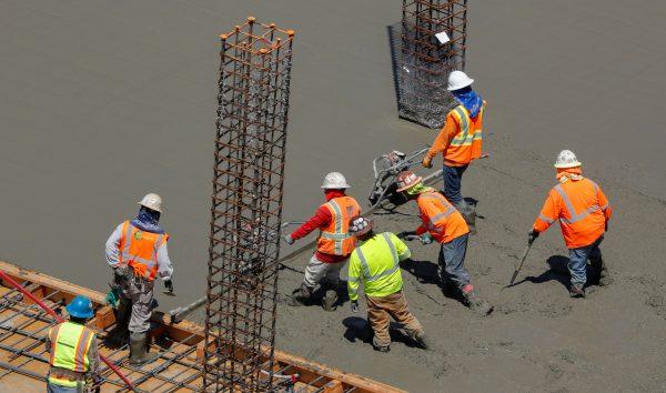 Workers pour cement at a construction site for an office town in downtown San Diego, Calif., on April 23, 2019. (Reuters/Mike Blake)