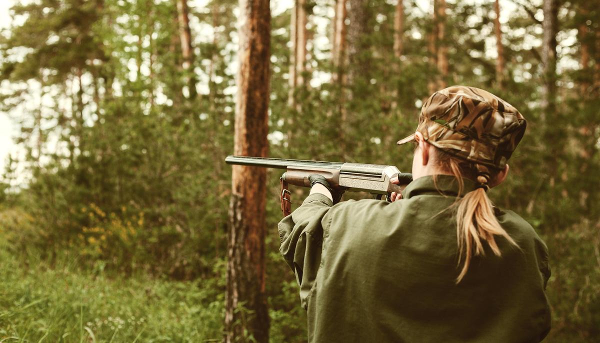 A hunter holds a gun in an illustration. (Illustration - Shutterstock)