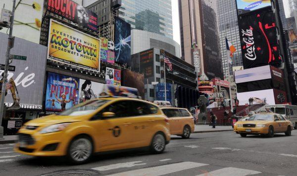 New York City taxis passing through New York's Times Square on Feb. 27, 2014. (Richard Drew/AP)
