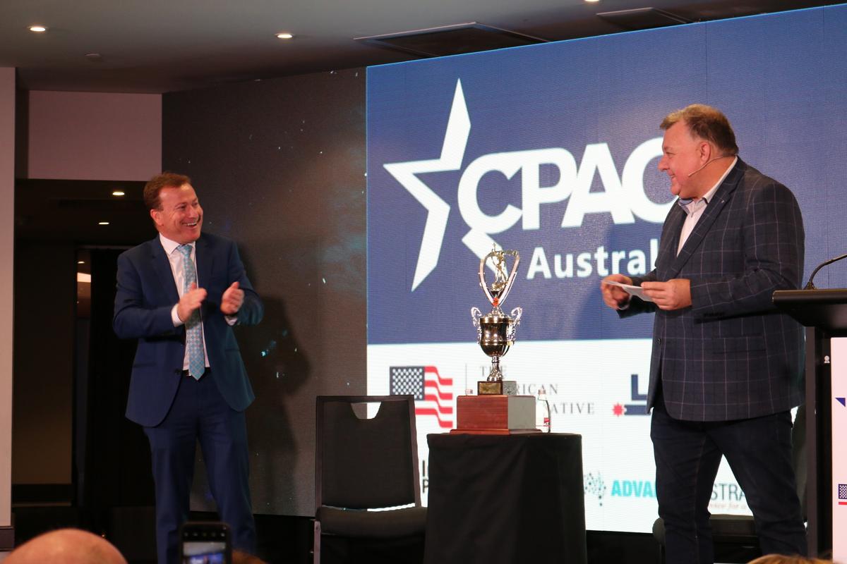 Australian Liberal MP Craig Kelly and LibertyWork's Andrew Cooper unveil the 'Keneally Cup' at the first Conservative Political Action Conference (CPAC) Australia on Aug. 10, 2019. (The Epoch Times)