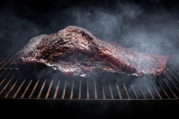 For perfectly smoked brisket, dose the smoke slowly and steadily for half a day. (Shutterstock)