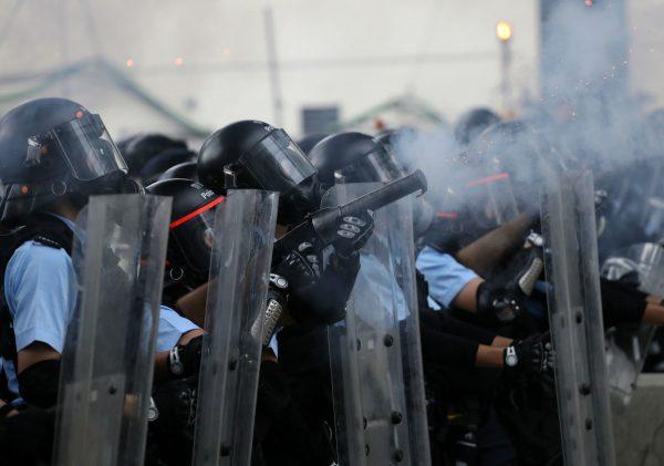Police officer fires tear gas at protesters during a demonstration against a proposed extradition bill in Hong Kong, China June 12, 2019. (Reuters/Athit Perawongmetha)