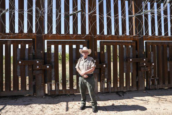 Cmdr. Kenny Bradshaw of the Cochise County Sheriff’s Office, stands next to the floodgates within the U.S.-Mexico border fence west of Naco, Arizona, on May 8, 2019. (Charlotte Cuthbertson/The Epoch Times)