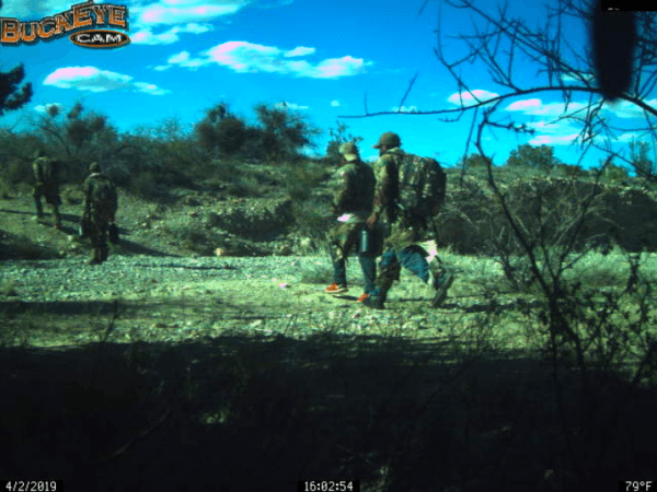 A motion-activated trail camera set by the Cochise County Sheriff's Office captures several illegal aliens carrying large backpacks on April 2, 2019. (Courtesy of Cochise County Sheriff's Office)