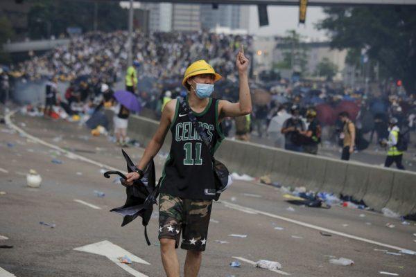 A protester gestures after clashes with riot police during a massive demonstration outside the Legislative Council in Hong Kong on June 12, 2019. (Kin Cheung/AP)