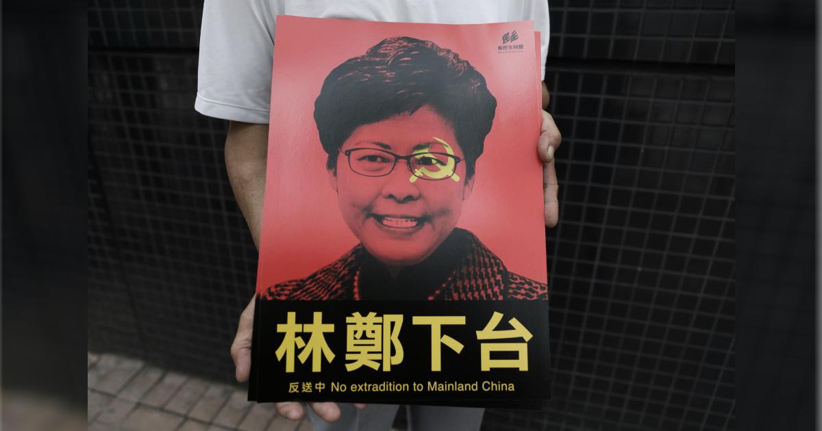 A protester holds posters showing Hong Kong Chief Executive Carrie Lam before a rally against a controversial extradition law proposal in Hong Kong on June 9, 2019. (Dale De La Rey/AFP/Getty Images)