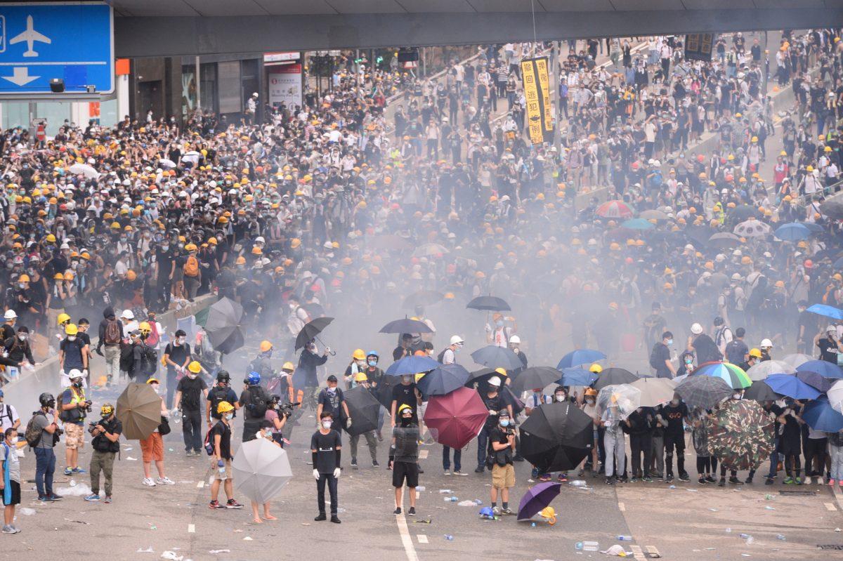 Police fired tear gas toward the protesters over 10 times near the Legislative Council of Hong Kong on June 12, 2019. (Song Bilong/The Epoch Times)