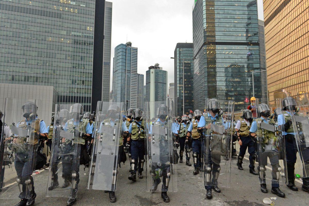 Police fired tear gas toward the protesters over 10 times near the Legislative Council of Hong Kong, on June 12, 2019. (Song Bilong/The Epoch Times)