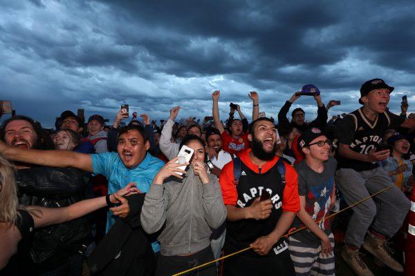 Fans react as the Toronto Raptors defeat the Golden State Warriors in the NBA Finals while watching on a large screen in a fan zone in Calgary, Alberta, Canada, June 13, 2019. (Todd Korol/Reuters)